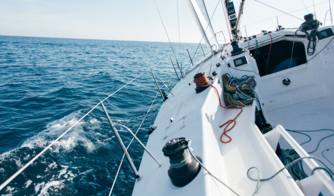 deck-professional-sailboat-racing-yacht-during-competition-sunny-windy-summer-day-moving-fast-through-waves-water-with-spinnaker-up